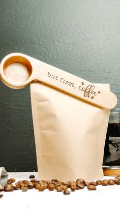 image of a wooden coffee spoon clipped onto coffee bag, the wooden spoon scoop is engraved with the words but first, coffee ideal gift for a coffee lover Coffee In The Morning, Spoon Gifts, First Coffee, But First Coffee