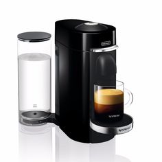 a white coffee maker with a glass next to it