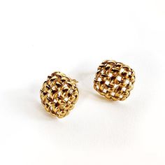 Make a statement with these timeless Givenchy Basket Weave Earrings. Crafted in gold tone hardware and crafted with vintage charm, they feature an intricate basket weave pattern to provide an exquisite and unique look. Perfect for any occasion, these earrings will be sure to elevate any ensemble. Gold plated metal Woven texture Clip ons Signed Length .5", Width .5" Very good vintage condition, slight wear throughout Gold Woven Jewelry Gift, Gold Woven Jewelry For Gift, Gold Woven Jewelry As A Gift, Elegant Woven Drop Earrings, Elegant Gold Woven Earrings, Gold Interwoven Jewelry Gift, Gold Jewelry With Interwoven Design For Gift, Gold Jewelry With Interwoven Design As Gift, Gold Woven Earrings As A Gift