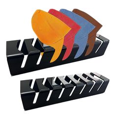 four different colored fish shaped bookends on black stands