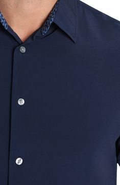 A crisp construction offers easy comfort to this short-sleeve button-up shirt that's great for work or play. Front button closure Spread collar Short sleeves 91% polyester, 9% spandex Machine wash, dry flat Imported Solid Color Button-up Dress Shirt, Classic Short Sleeve Button-up Shirt With Snap Buttons, Short Sleeve Workwear Shirt With Buttons, Work Shirt With Snap Buttons, Solid Shirt With Snap Buttons For Work, Solid Color Collared Shirt With Functional Buttons, Solid Color Workwear Shirt With Snap Buttons, Solid Work Shirt With Snap Buttons, Solid Short Sleeve Button-up Shirt For Business Casual