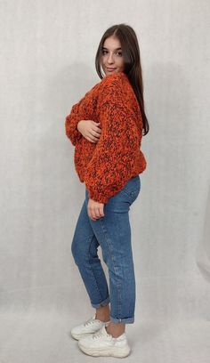 "OVERSIZE Handmade wool cardigan, warm woolen sweater. OVERSIZE warm, handmade, beautiful orange cardigan made of wool and mohair. The sweater has a universal shape and is carefully finished with a drawstring. The sweater is fastened with a safety pin, so you can adjust it accordingly. Sweater dimensions measured flat; width 58 cm length 53 cm The model in the photo is 165 cm tall and wears size M. The cardigan fits women wearing sizes 38 to 42. Design and workmanship by HERMINA  Composition: 50% wool 50% mohair  We recommend hand washing in lukewarm water with a mild liquid. Dry flat in the unfolded position. From time to time, the sweater can be \"bathed\" in cool water with hair conditioner to smooth the fibers and obtain a soft effect. After such treatment, dry as above. Please remembe Orange V-neck Knit Sweater, Orange Acrylic Winter Sweater, Hand Knitted V-neck Sweater For Fall, Orange Long Sleeve Cardigan For Winter, Orange Soft Knit Long Sleeve Sweater, Orange Long Sleeve Soft Knit Sweater, Winter Knitted Orange Outerwear, Orange Knitted Outerwear For Winter, Winter Orange Knitted Outerwear