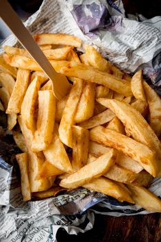 a pile of french fries with a knife in it