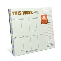 this week planner with orange sticker on the front and back cover, is shown