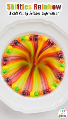 a bowl filled with gummy bears sitting on top of a white plate next to a sticker