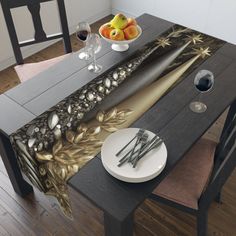 the table is set with silverware and fruit on it, along with an artisticly designed placemat