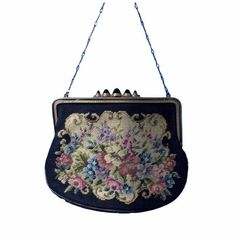 A beautiful Austrian made petite point purse, the tapestry like design depicting pretty flowers on an off white ground with black border. The frame of the purse is painted with black cold enamel in the groove at the front, and engraved on the back, and the clasp is set with the most incredible black glass cabochons with a deep, almost comically dome. There is a barley twist chain handle and the purse is lined with an eau de nil faille. Condition is very good. There are general minor signs of age Cold Enamel, Barley Twist, Black Border, Black Glass, Clutch Handbag, Pretty Flowers, Evening Bags, Purses And Handbags, Tapestry