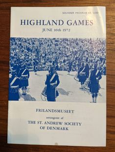 the front cover of highland games magazine on a wooden table with an image of people in uniform