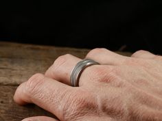 The Apex ring is the polar opposite of a traditional, boring men's wedding bands. The anti-jewelry! This ring is as far as you can get from the all too common, plain, shiny men's band. The Apex ring is constructed from solid titanium, that means that it's super lightweight on your finger and durable too! The texture is a prominent feature of the ring, but it is smoothed out so it IS NOT sharp and catching. Free shipping in the USA! Every Richter Scale ring is covered by our 100% Guarantee About Silver Titanium Promise Ring, Adjustable Silver Titanium Rings, White Gold Titanium Promise Ring, Classic Silver Titanium Rings, Classic Titanium Ring With Polished Finish, Classic Titanium Wedding Jewelry, Classic Titanium Jewelry For Wedding, Richter Scale, Traditional Wedding Bands