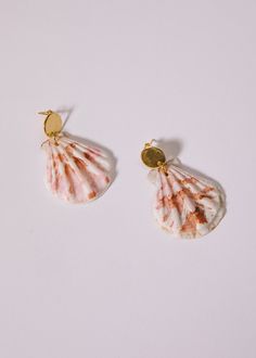 Bring a touch of seaside charm to any outfit with these gorgeous natural shell earrings. Perfect for summer events, these scalloped shell earrings are sure to make a lasting impression. Please note: shells are natural and may vary in color and size. Mother Of Pearl Shell With Pearl Drop, Pearl Drop Shell Earrings, White Shell Beachy Earrings, Ocean-inspired Shell Earrings With Ear Wire, Handmade Shell-shaped Beachy Earrings, Ocean-inspired Shell-shaped Earrings For Gifts, Beachy Shell Dangle Earrings, Ocean-inspired Shell Drop Earrings, Summer Shell-shaped Earrings With Ear Wire