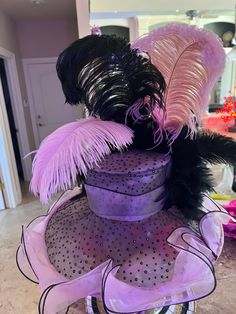 Pink and black trimmed ruffle derby style hat with sparkle polka dots . Handcrafted by designer with giant matching bow, black feather boa, black and pink feathers Feather Trim Costume Hats For Kentucky Derby Races, Fitted Feather Trim Top Hat For Party, Kentucky Derby Flapper Costume Hats And Headpieces For Party, Kentucky Derby Costume Hats With Feather Trim, Flapper Hats For Kentucky Derby Party, Kentucky Derby Black Feathered Costume Hats, Flapper Style Hat For Kentucky Derby Party, Black Feather Trim Mini Hats For Kentucky Derby, Black Mini Hats With Feather Trim For Kentucky Derby