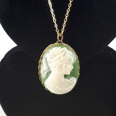 Lovely vintage Victorian Revival portrait of a woman cameo necklace. Features a resin cameo on a green background that is bezel set in gold tone metal. In very good pre-owned condition with minor signs of wear. The gold tone chain measures 16 inches long, the cameo is 1 5/8 x 1 1/4 inches. Please message me if you have questions before you purchase as all vintage items are sold as is. Thank you for viewing my listing! Please visit my shop for more vintage antique jewelry and treasures: https://www.etsy.com/ca/shop/RhinestoneValley Victorian Green Cameo Jewelry, Antique Green Cameo Jewelry, Green Medallion Necklace For Formal Occasions, Mid Century Pendant, Victorian Revival, Vintage Portrait, Portrait Of A Woman, Cameo Necklace, Vintage Antique Jewelry