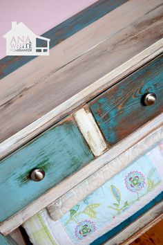 an old dresser has been painted blue and green