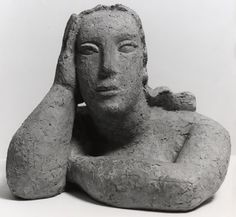 a stone statue sitting on top of a white surface