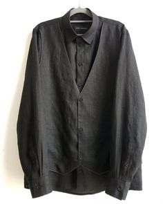 Mens shirt / Mens black long sleeve Linen dress shirt with a built-in Vest by NARGASSI has a regular yet a bit loose fitting silhouette through the body, crafted in a high quality Linen fabric, the black dress shirt features a unique high collar, classic button through placket with matching black buttons and a rounded hem, and classic buttons for the Vest.*** Please note, the model is wearing a shirt without buttons on the Vest, you can choose to have the Vest with or without buttons.Please upda Formal Long Sleeve Shirt With Pockets, Black Spread Collar Top With Hidden Button Closure, Black Tops With Hidden Button Closure And Spread Collar, Semi-formal Long Sleeve Dress Shirt With Hidden Button Closure, Black Long Sleeve Tops With Hidden Button Closure, Black Long Sleeve Top With Hidden Button Closure, Black Business Shirt With Pockets, Modern Black Shirt With Lapel Collar, Formal Black Shirt With Pockets