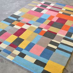 a multicolored rug on the ground with no one in it or someone else