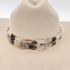 The Willow Western Feather Hat Band features a 3 cm width and an approximate length of 58 cm, excluding the leather ties. Designed to fit most sizes, this hat band is easily adjustable with leather ties, ensuring a comfortable and secure fit. The feather detailing adds a graceful, rustic touch, making it an ideal accessory for those who appreciate subtle western-inspired elegance. Cheap Brown Hat Bands For Festivals, Luxury Adjustable Hat Bands With Feathers, Luxury White Western Style Hat Bands, Luxury White Country Hat Bands, Cowgirl Dress Up, Feather Hat Band, Iridescent Feathers, Cowboy Hat Band, Cowgirl Dress