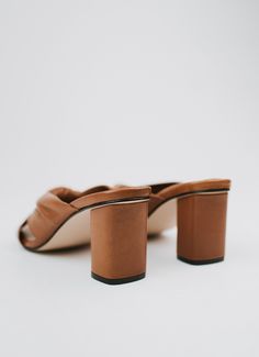 The mule version of our beloved Teresa Sandals. Crafted with meticulous attention to detail, these mules are designed to feel like you're walking on clouds. The Teresa mules have cushioned soles that provide unparalleled support and comfort for all-day wear. Featuring a beautifully crafted leather knot, these mules effortlessly elevate any outfit, adding a touch of sophistication to your look. DETAILS 100% LeatherHandmade in Mexico3.5 inch heel Brown Slip-on Slides For Spring, Elegant Brown Slip-on Slippers, Brown Closed Toe Slides For Spring, Modern Slip-on Mules With Heel Loop, Chic Brown Leather Slides, Brown Formal Mules For Spring, Brown Spring Formal Mules, Formal Brown Mules For Spring, Brown High Heel Mules For Spring