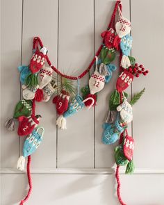 an ornament hanging on the side of a white wall with christmas decorations attached to it