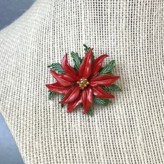 "Vintage Roma FAIRDEAL Christmas Flower Brooch, Red Green Enamel Brooch, Signed Lapel Scarf Decorations Pin, Gift for Friend. Era: 1963. Designer Signed: Roma with a copyright. ( FAIRDEAL MANUFACTURING CO.) Measurements: - Length : 1 5/8\" inches - Width: 1 1/2\" inches Details: -Metal Color: Gold. - Embellishments: Gold tone Plating, White Enamel, Green and Red Enamel, a Christmas Flower Shaped Brooch. - Closure: Claps Rollover. Here are more Vintage Jewelry items for your viewing pleasure: htt Vintage Red Brooches For Festive Occasion, Holiday Red Brooch Jewelry, Red Christmas Brooch For The Holidays, Red Christmas Brooch For Holidays, Red Holiday Brooch, Red Flower Brooches For Gift, Red Christmas Holiday Brooch, Red Christmas Holiday Brooches, Elegant Red Christmas Brooches