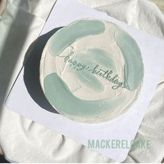 a birthday cake with the words happy birthday written on it, sitting on a napkin