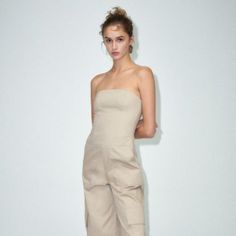 Long Cargo Jumpsuit Strapless Long Jumpsuit With Straight Neckline. Side Pockets And Patch Pocket At Leg. Side Hidden In-Seam Zip Closure. Wide Leg Cargo Cut With High Waist. Celeb, Blogger And Tiktok Fave! Perfect For Your Upcoming Beach Vacay And All Summer Long! Size S 15" Across Top Hem (Armpit To Armpit Approx) 14.5" Across Waist 11" Top To Waist 21" Across At Hips 11" Rise 12.5" Across At Thigh 33" Inseam Outer Shell 100% Cotton Lining 100% Polyester Zara Strapless Jumpsuits And Rompers For Summer, Beige Strapless Jumpsuit For Summer, Fitted Beige Zara Jumpsuits And Rompers, Chic Summer Overalls By Zara, Zara Beige Jumpsuits And Rompers For Summer, White Lace Jumpsuit, Summer Onesies, Oversized Jumpsuit, Cargo Jumpsuit