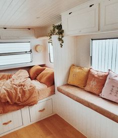 a bed sitting inside of a bedroom on top of a wooden floor next to a window