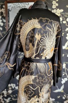 Oh I do love a dragon kimono and this is a beauty! Made of a substantial satin silk  heavily decorated with goldwork embroidery and lined in soft black silk. This also has an original sash belt, which could do with some tlc, as it has worn seams and the embroidery is lifting. The robe itself is overall in lovely condition. There is the odd loose gold thread, which is certainly not detrimental. A small nibble to the hip area as photographed, but overall a show stopping item! Photographed on my UK Gold And Silver Embroidery, Dragon Kimono, Goldwork Embroidery, Loose Kimono, Embroidered Kimono, Black Kimono, Kny Oc, Sash Belts, Sash Belt