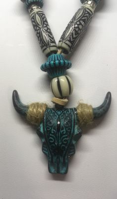 Southwestern themed mens cow skull necklace . Cow skull is turquoise enamel plated metal strung on light brown leather cord. Turquoise and white colored beads along with silver plated beads accompany the skull. Cow Jewelry, Dragon Designs, Metal Skull, Enamel Plate, Necklace Mens, Light Brown Leather, Cow Skull, Skull Necklace, Acid Reflux