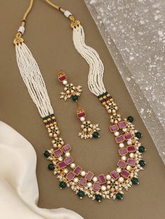 Your jewelry collection with this exquisite Heer Rajwadi Meenakari necklace and Maharashtrian earrings set, featuring stunning green and pink stones. Handcrafted with precision and attention to detail, this set is perfect for adding a touch of elegance to any outfit. The combination of pearl beads and colorful stones creates a unique and eye-catching look that is sure to turn heads. Ideal for special occasions or everyday wear, this set is a must-have for any jewelry lover. Style & Look: Elevate your style and look with our exquisite Heer Rajwadi Meenakari necklace and Maharashtrian earrings set. Handcrafted with meticulous attention to detail, this stunning jewelry set features vibrant green and pink stones paired with lustrous pearl beads, creating a captivating and unique design. The in Festive Chandbali Necklaces With Matching Earrings, Chandbali Necklaces With Matching Earrings For Diwali, Kundan Necklaces With Matching Earrings For Festivals, Pink Pearl Drop Chandbali Earrings, Pink Pearl Drop Chandbali Jewelry, Bollywood Festive Necklaces With Matching Earrings, Festive Green Pearl Drop Necklace, Green Meenakari Pearl Necklace Gift, Traditional Festive Necklaces With Matching Earrings