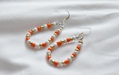 Silver Plated / 18k Gold Plated ear hooks Nickel free These handmade orange and white beaded earrings are the perfect addition to any outfit. They are lightweight, comfortable, and made of hypoallergenic materials.  2.5 inches in length. Care Instructions: - Keep away from moisture - Remove when sleeping - Remove before entering water - Store in cool dry area - Gently wipe with soft cloth to clean These unique handmade earrings would make the perfect birthday gift, anniversary gift, bridesmaid g Tennessee Game Day, White Beaded Earrings, Tennessee Orange, Tn Vols, Unique Handmade Earrings, Orange Earrings, Colorful Earrings, White Gold Earrings, White Earrings