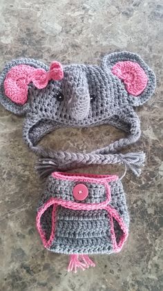 two crocheted hats with pink bows on top and one in the shape of a mouse