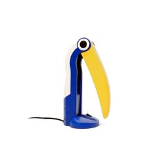 a blue and yellow bird shaped lamp on a white background