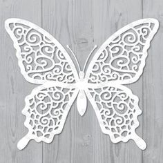 a white butterfly cutout on a wooden background