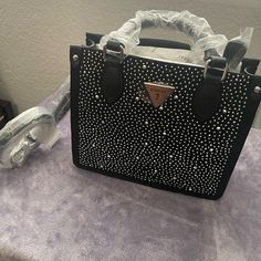 Guess Issa/ Alcey Mini Tote Bag Black With Rhinestones Comes With Crossbody Strap New With Tag And Protectors Top Handle Shoulder Bag With Rhinestones For Everyday, Trendy Party Bags With Rhinestone Rivets, Designer Evening Bags With Silver Accents, Evening Black Bags With Rhinestone Rivets, Chic Silver Bags With Rhinestones, Luxury Silver Shoulder Bag With Rhinestones, Designer Leather Shoulder Bag With Rhinestones, Chic Rhinestone Bags For Shopping, Elegant Everyday Bags With Rhinestone Rivets