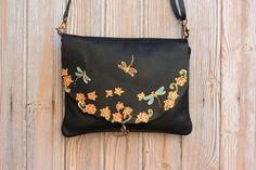 "► Our FREE delivery is TRACKED, secure and super FAST! Please provide a PHONE number for DHL express delivery. This dragonfly leather crossbody women's leather handbag is entirely hand-made with the best quality Spanish cowhide leather. The bag is handpainted with a colorful nature-inspired design in orange, turquoise, and other vibrant colors and decorated with a brass pendant of a dragonfly. This women's purse is very lightweight and feels soft and smooth. We design and hand paint our product Hand Painted Leather Tote Shoulder Bag, Hand-painted Leather Tote Shoulder Bag, Hand Painted Leather Crossbody Bag, Leather Hand Painted Crossbody Bag, Hand Painted Satchel Bag For Everyday Use, Everyday Hand Painted Shoulder Bag, Everyday Rectangular Hand Painted Shoulder Bag, Everyday Rectangular Hand-painted Shoulder Bag, Artisan Black Crossbody Bag