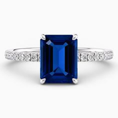 an emerald - cut blue sapphire and diamond ring in 18k white gold with side stones