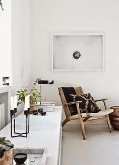 a living room filled with furniture and pictures on the wall