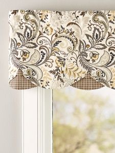 the window is decorated with an ornate pattern and valance, along with a plaid table cloth