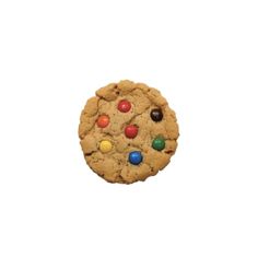 a cookie with m & m's on it is in front of a white background