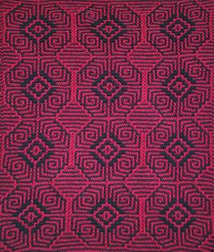 a red and black crocheted blanket with an intricate design