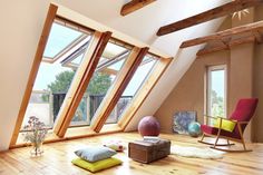 a room with wooden floors and large windows