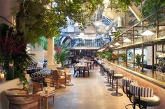 Beautifully decorated restaurant with leafy greenery and high ceilings Cafe Rooftop, Victoria Station London, Bistro Cafe Design, Bars In London, Luxury Building, Wood Burning Oven, Breakfast Places