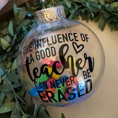 a glass ornament that says the influence of a good teacher can never be erased