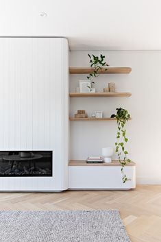 a living room filled with furniture and a fire place next to a wall mounted tv