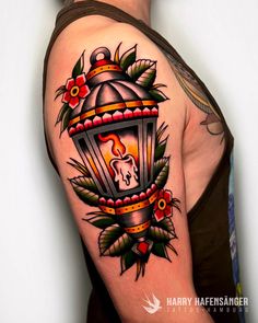 a man with a lantern tattoo on his arm