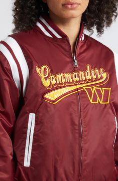 Gear up for game day with this Washington Commanders bomber jacket from WEAR by Erin Andrews. Featuring bold graphics across the front and back, this jacket celebrates the team's founding year. The contrast stripes and pockets add a stylish finish to this sleek Washington Commanders jacket. Imported Long sleeve Full Zip Ribbed collar, sleeve trimmings, cuffs & waist/hem Machine wash with garment inside out, tumble dry low Material: 100% Nylon - Body; 100% Polyester - Lining; 95% Polyester/5% Spa Collegiate Outerwear With Team Name For Game Day, Varsity Outerwear For Game Day With Team Name, Varsity Outerwear With Team Name For Game Day, Team-colored Outerwear For Game Day With Team Spirit, Team-colored Outerwear For Game Day, Team Outerwear For Game Day, Sporty Game Day Outerwear With Team Name, Collegiate Team-colored Outerwear For College, Collegiate Winter Track Jacket For Game Day