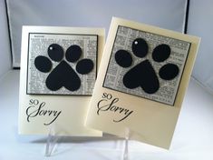 two cards with dog paw prints on them, one says sorry and the other says sorry