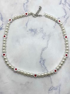 This necklace has 6mm glass pearls and heart beads. The necklace is accented with silver colored clasps. The necklace is 16 inches from the clasp to the last link of the extender. Pearl And Heart Necklace, Colored Pearls Jewelry, Beaded Jewelry Heart, Heart Beads Necklace, Beaded Pearl Necklace For Valentine's Day, Pearl Necklace With Heart-shaped Beads, Heart-shaped Pearl Beaded Necklace, Heart-shaped Pearl Necklace, White Beaded Necklaces For Valentine's Day