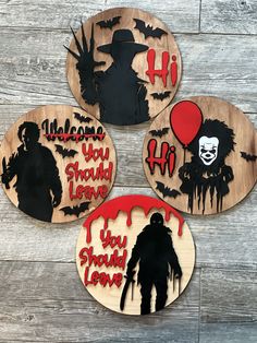 three wooden halloween coasters with silhouettes of zombies, balloons and the words you should leave on them